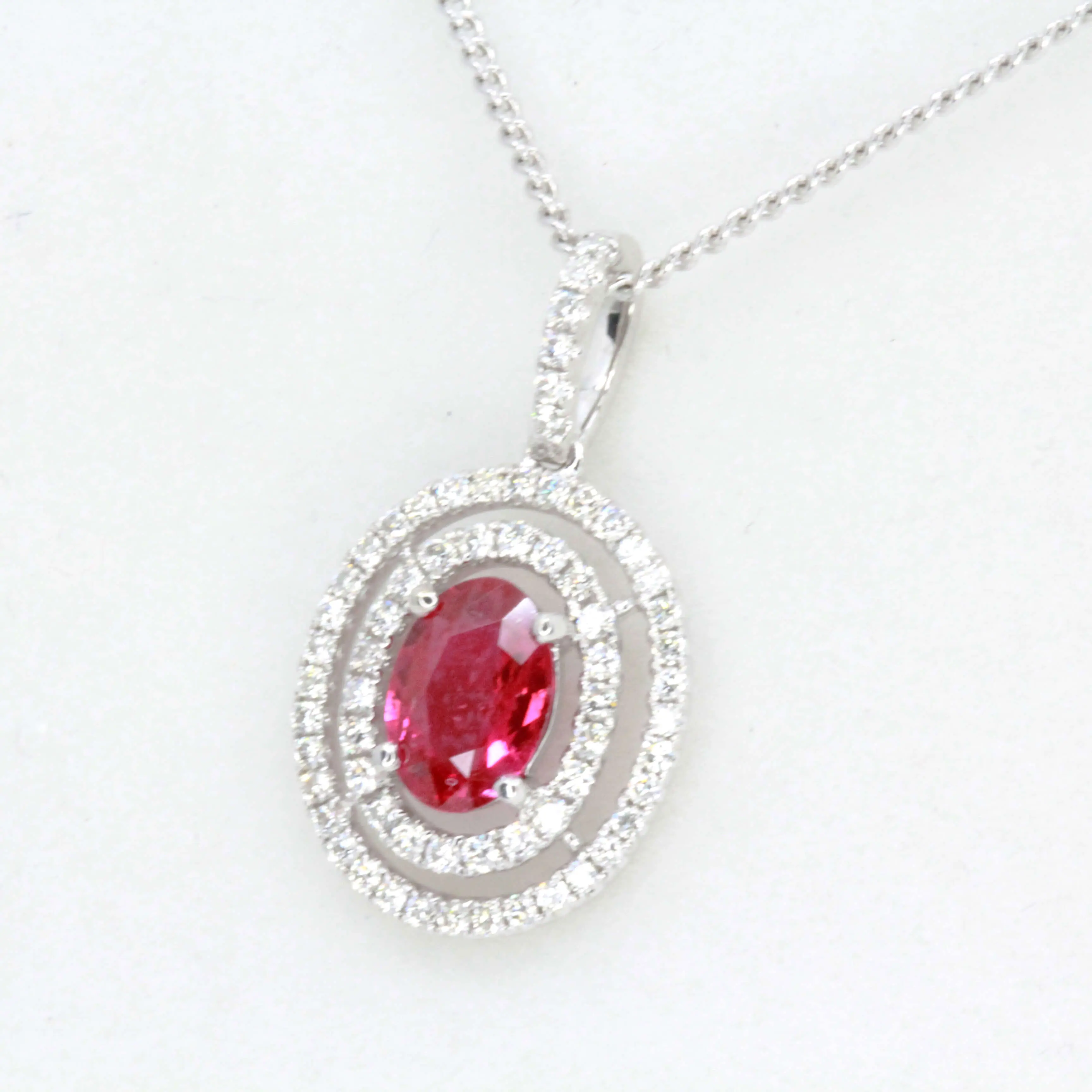 Oval Ruby Pendant with Halo of Diamonds set in 18ct White Gold