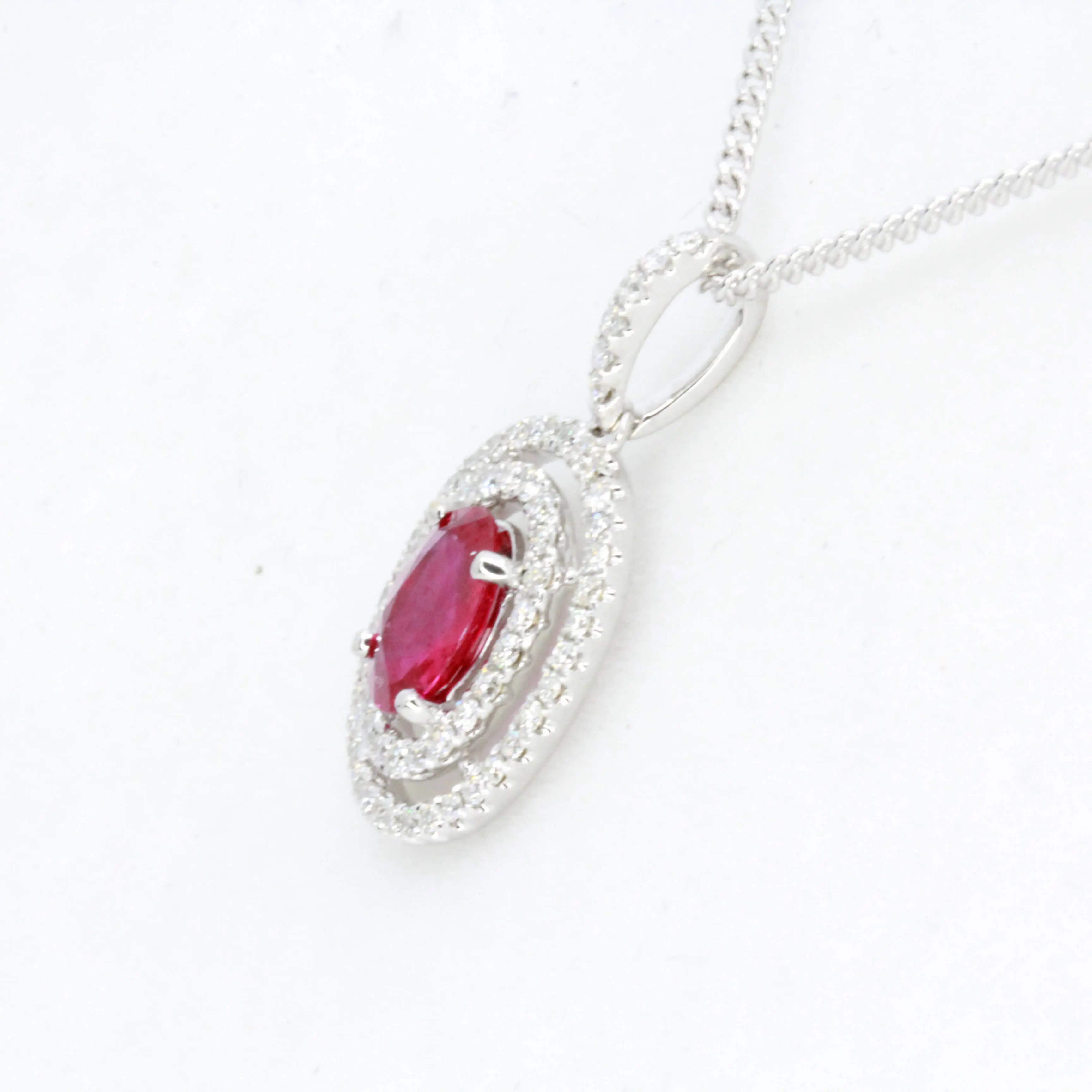 Oval Ruby Pendant with Halo of Diamonds set in 18ct White Gold
