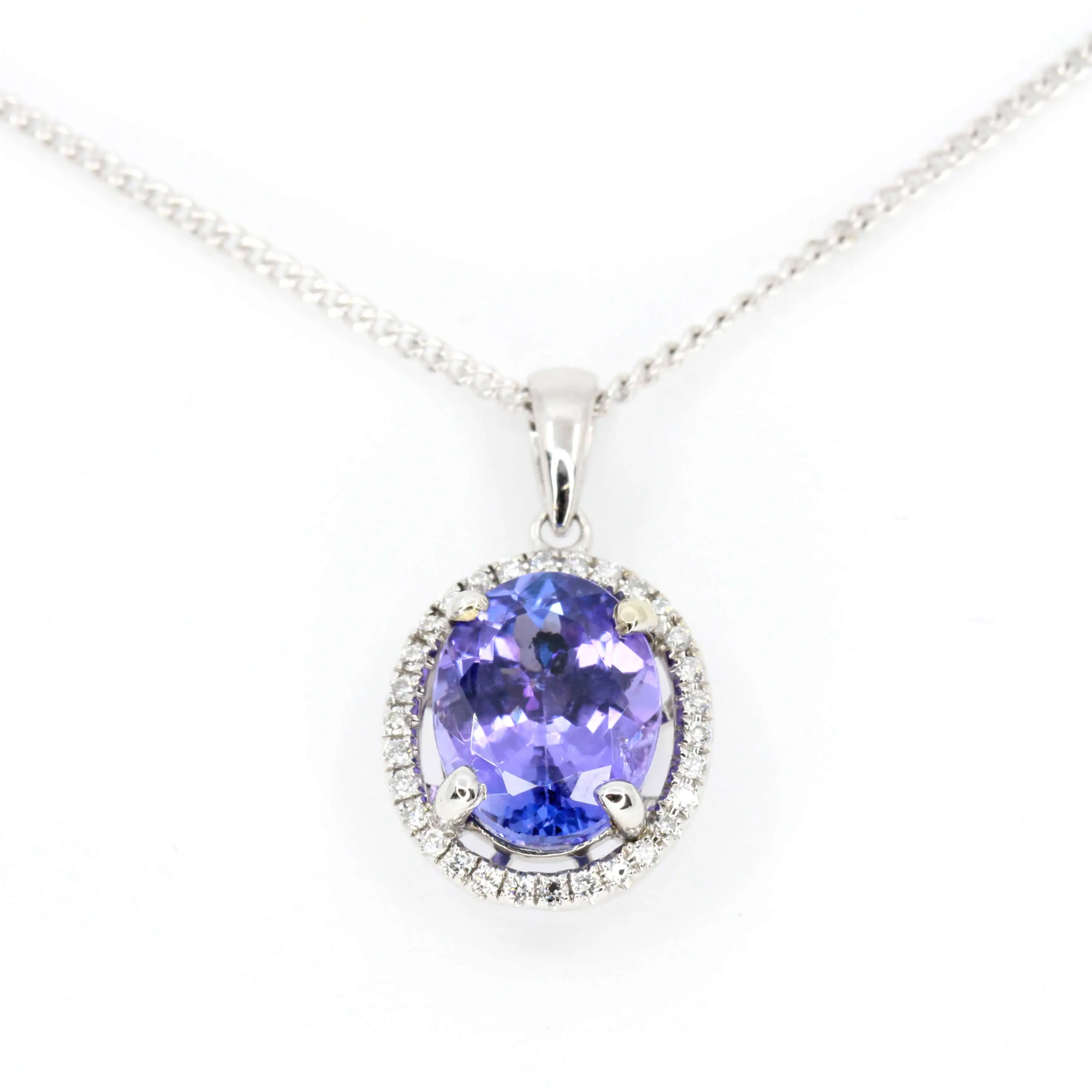 Oval Tanzanite Pendant with Halo of Diamonds set in 18ct White Gold