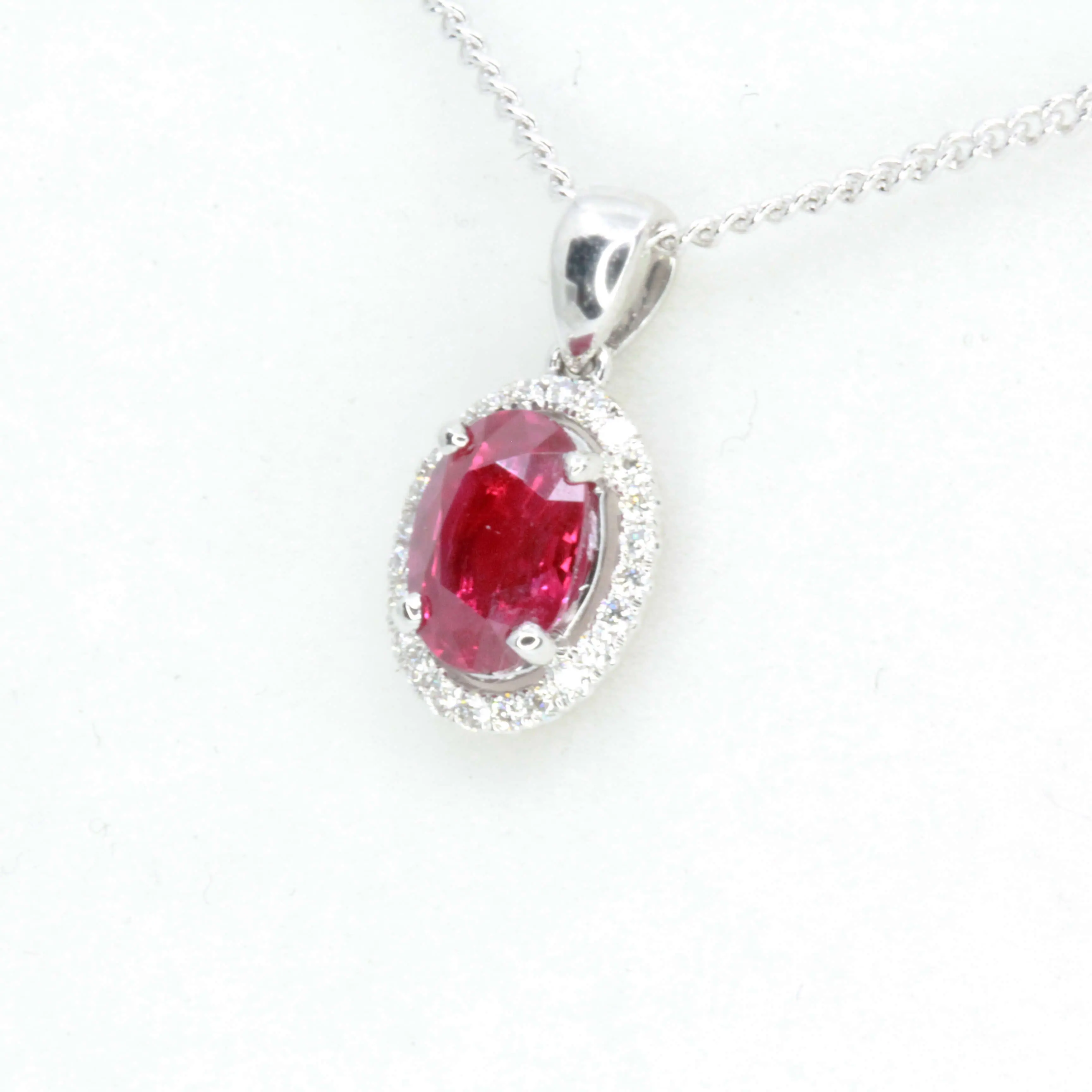 Oval Ruby Pendant with Halo of Diamonds set in 18ct White Gold