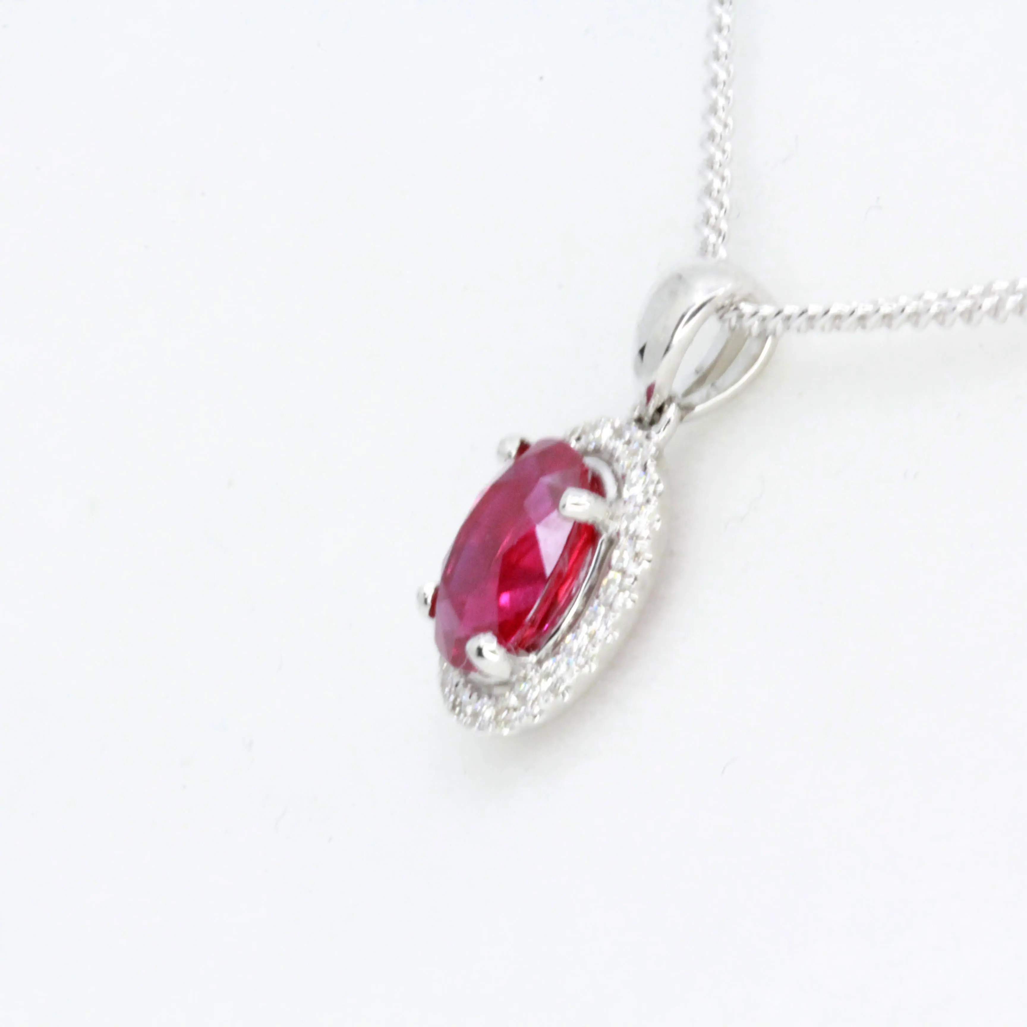 Oval Ruby Pendant with Halo of Diamonds set in 18ct White Gold