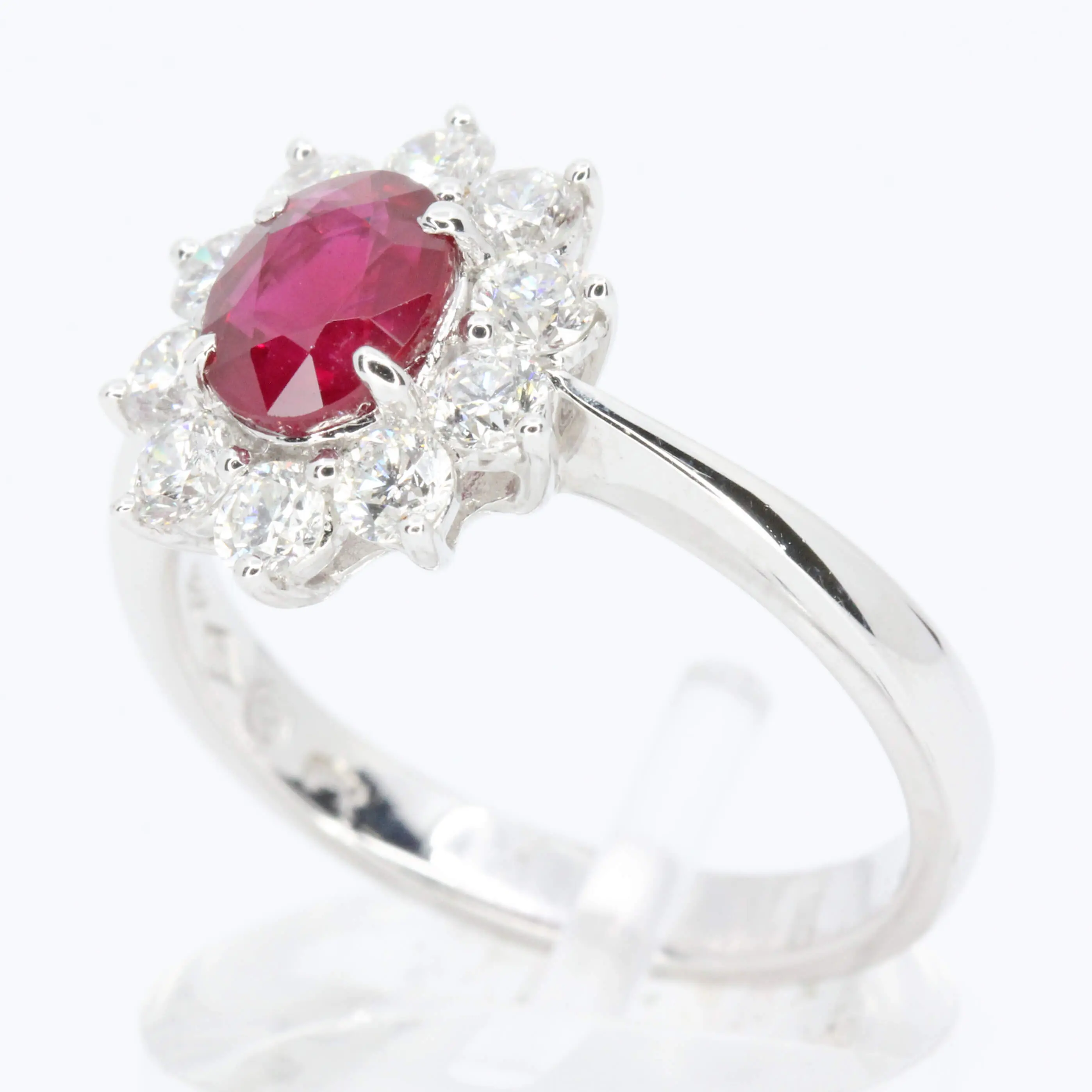Oval Cut Ruby Ring with Diamond Halo Set in 18ct White Gold