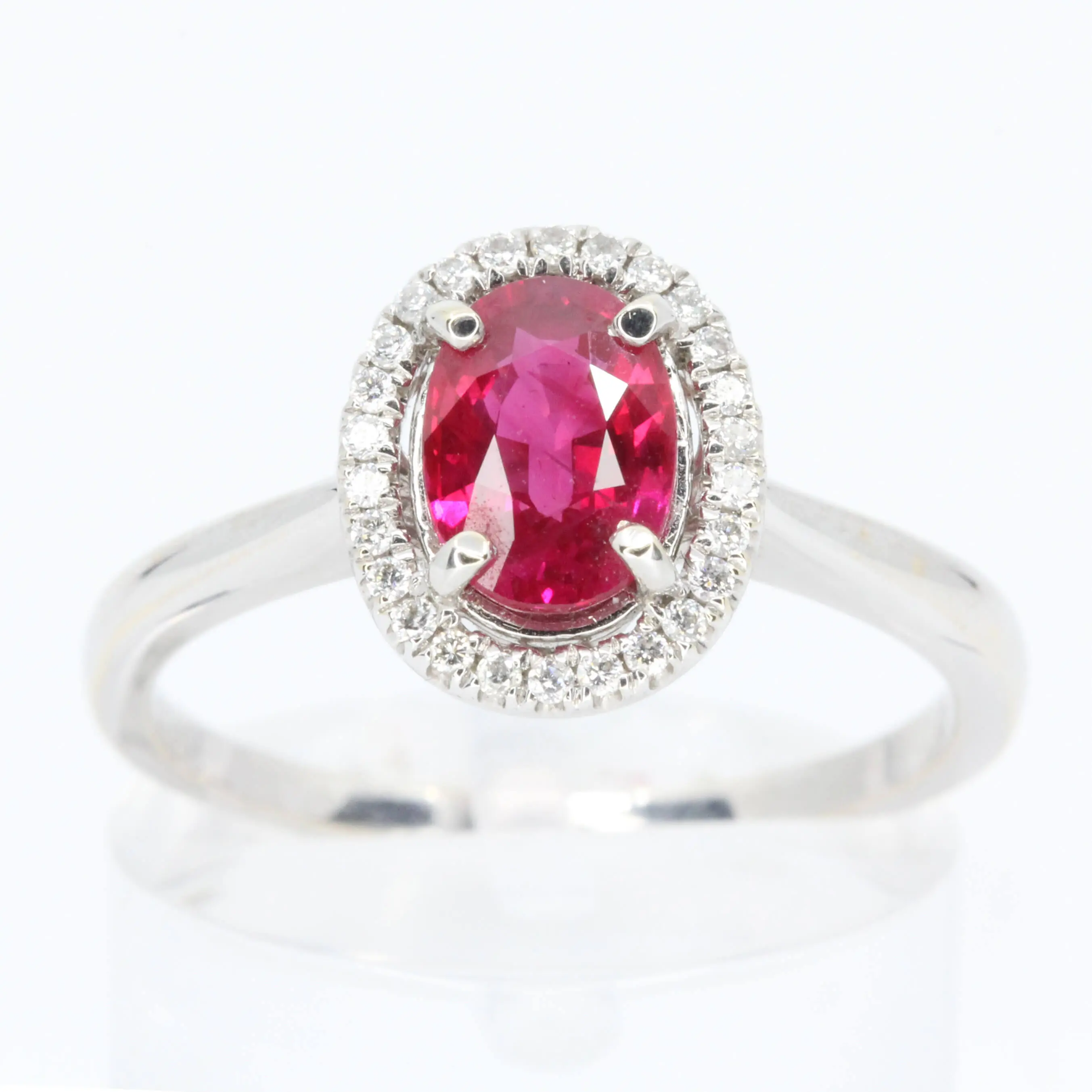 Oval Cut Ruby Ring with Diamond Halo Set in 18ct White Gold