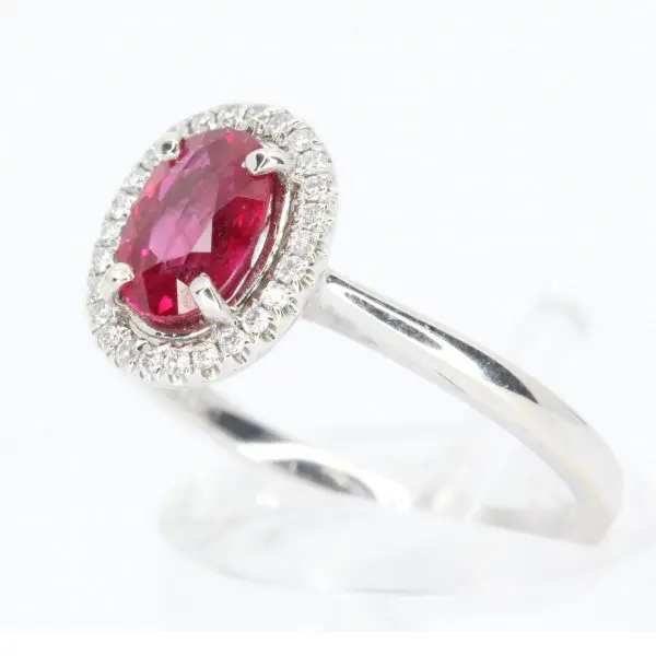 Oval Cut Ruby Ring with Diamond Halo Set in 18ct White Gold