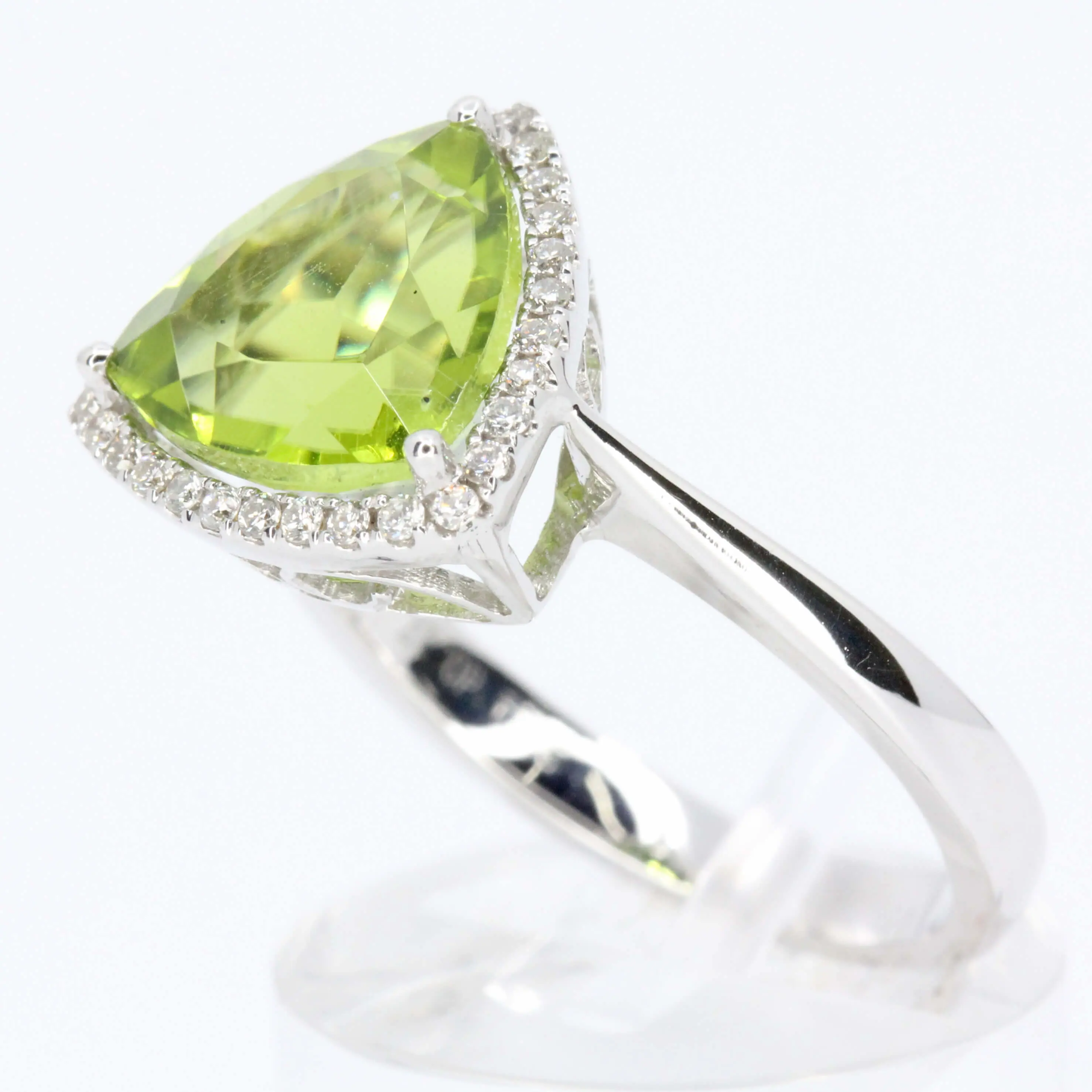 Trillion Cut Peridot Ring with Halo of Diamonds Set in 18ct White Gold