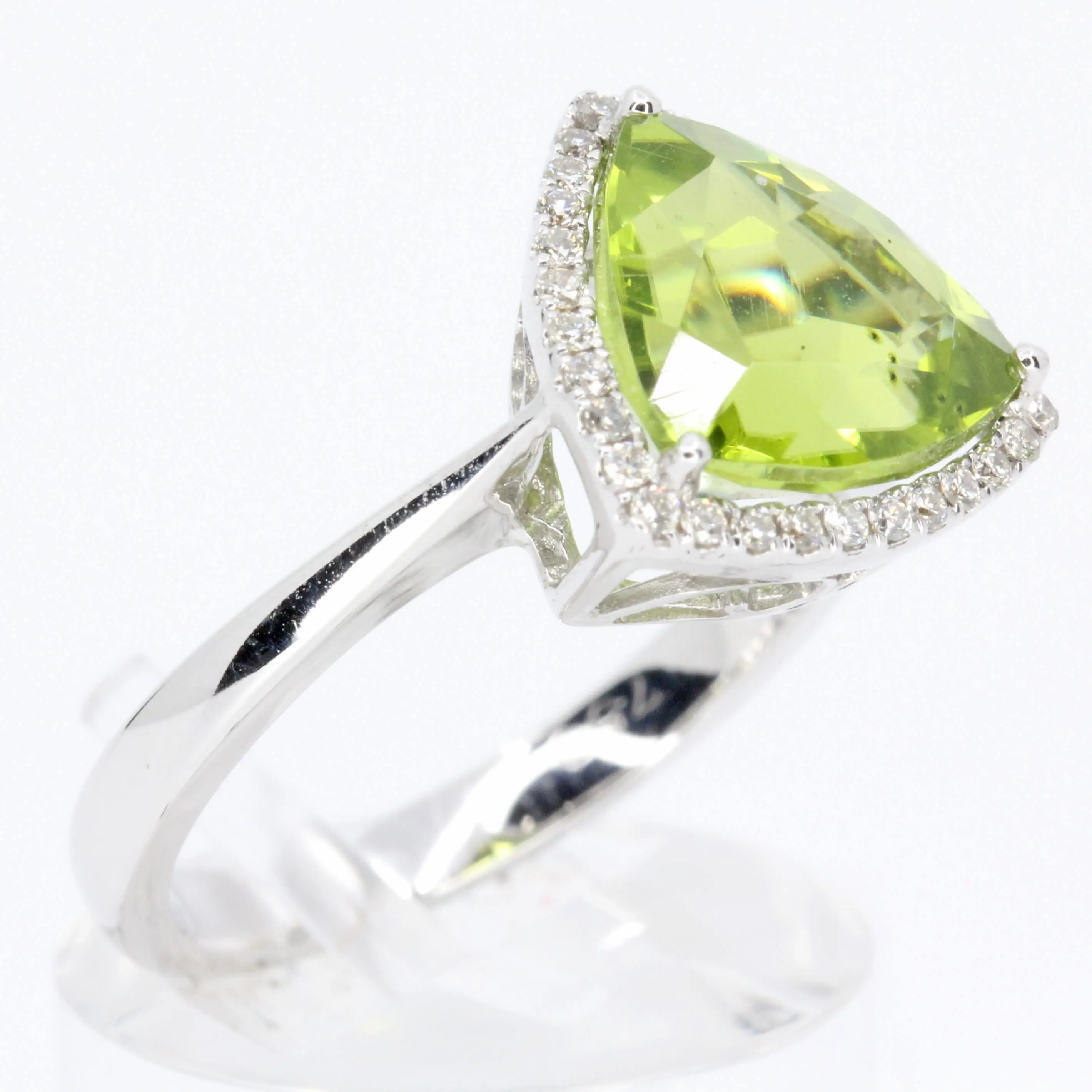 Trillion Cut Peridot Ring with Halo of Diamonds Set in 18ct White Gold