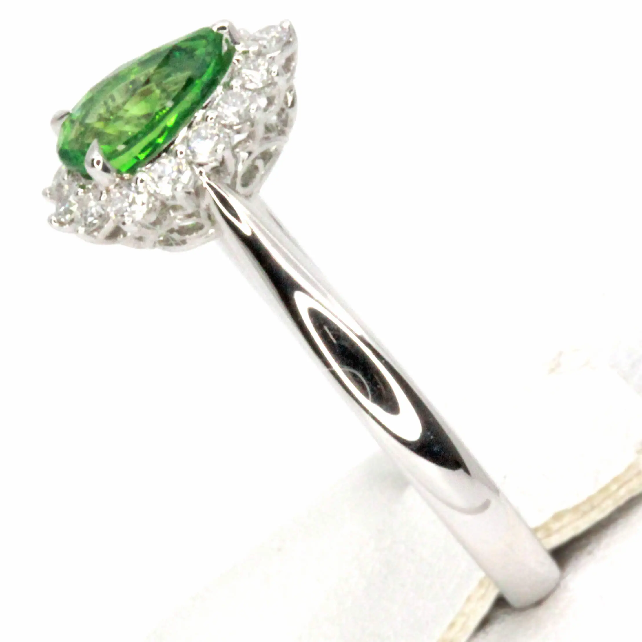 Pear Cut Tsavorite Ring with Halo of Diamonds Set in 18ct White Gold