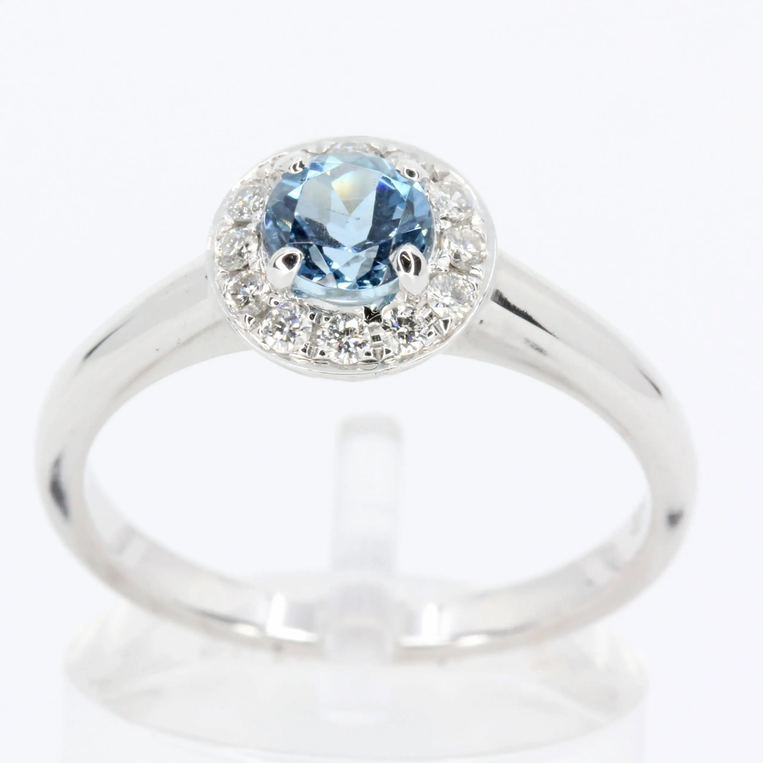 Round Cut Aquamarine Ring with Halo of Diamonds Set in 18ct White Gold