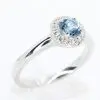Round Cut Aquamarine Ring with Halo of Diamonds Set in 18ct White Gold