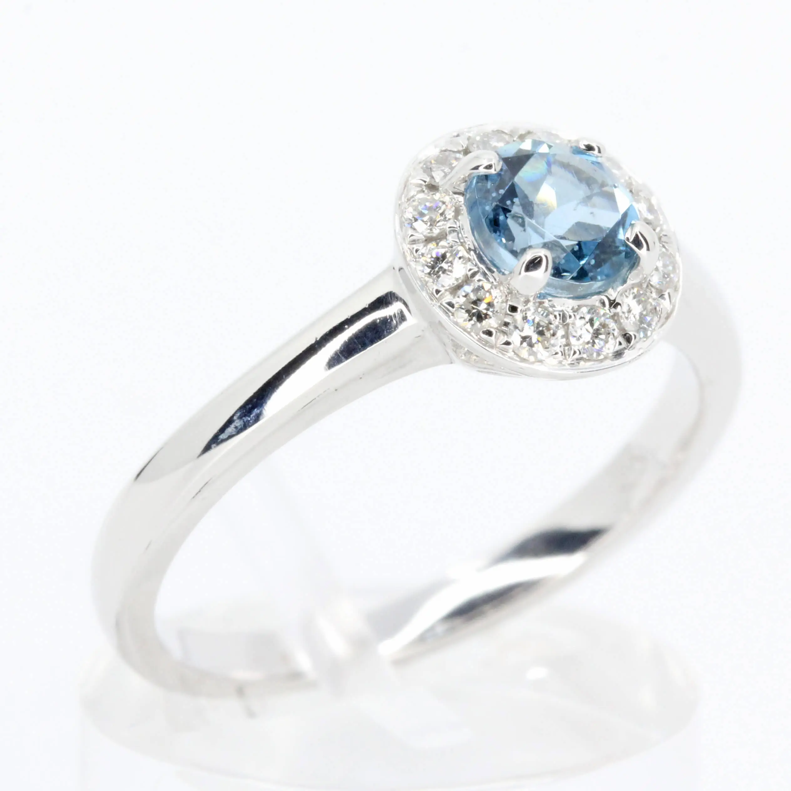 Round Cut Aquamarine Ring with Halo of Diamonds Set in 18ct White Gold