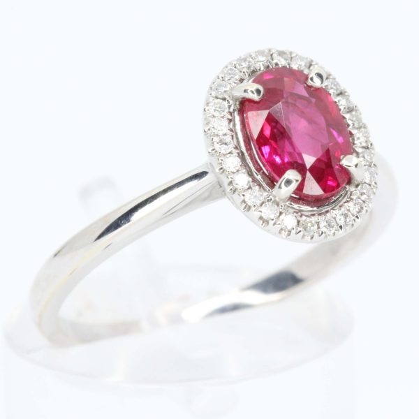 Oval Cut Ruby Ring with Diamond Halo Set in 18ct White Gold