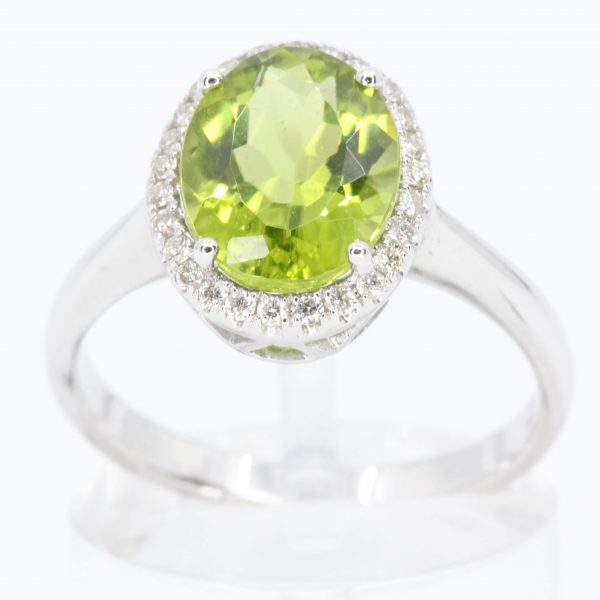 Oval Cut Peridot Ring with Diamond Halo Set In 18ct White Gold