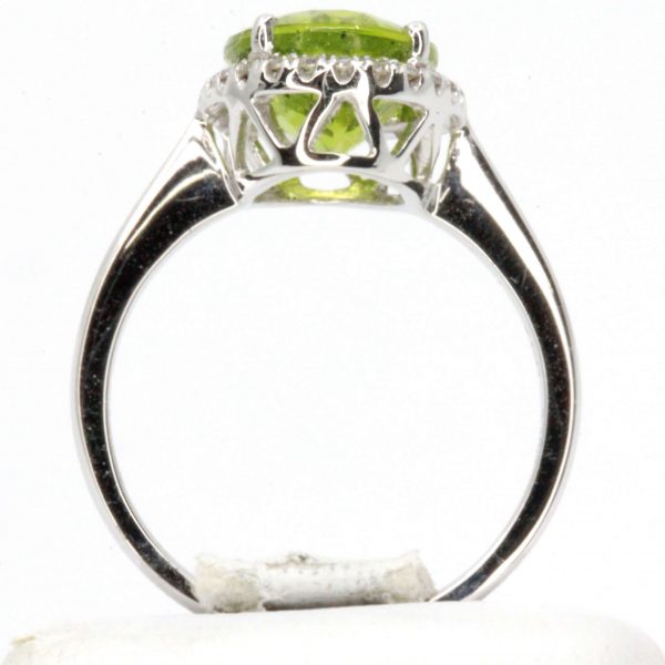 Oval Shape Peridot Ring with Halo of Diamonds Set in 18ct White Gold