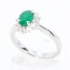 Oval Shape Emerald Ring with Halo of Diamonds Set in 18ct White Gold