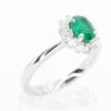 Oval Shape Emerald Ring with Halo of Diamonds Set in 18ct White Gold