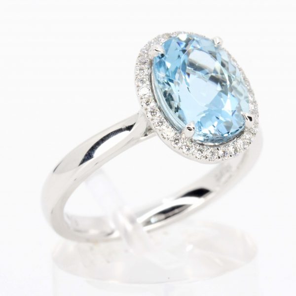 Oval Shape Aquamarine Ring with Halo of Diamonds Set in 18ct White Gold
