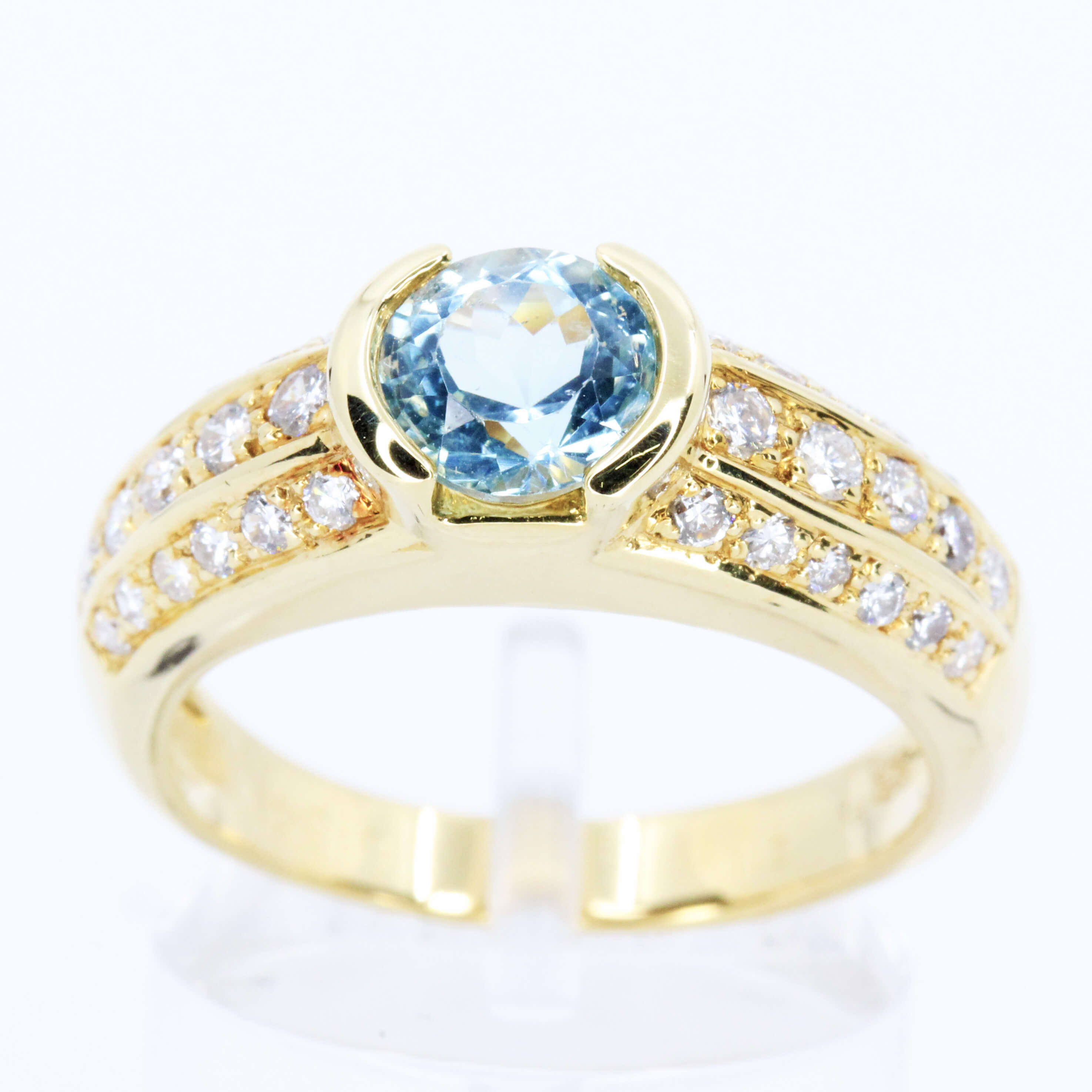 Round Cut Blue Topaz Ring with Accents of Diamonds Set in