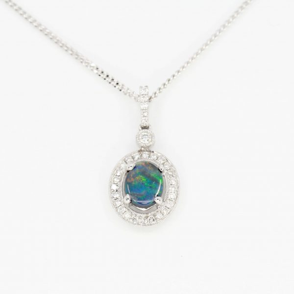 Oval Black Opal Pendant with Halo of Diamonds set in 18ct White Gold