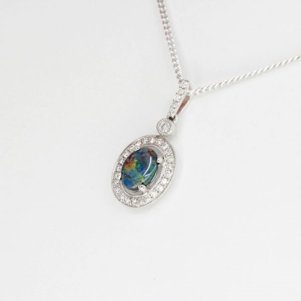 Oval Black Opal Pendant with Halo of Diamonds set in 18ct White Gold