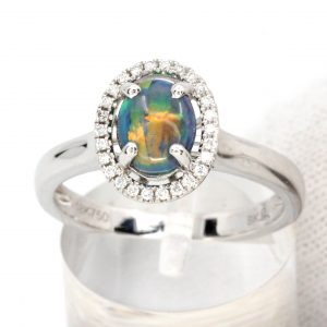 Oval Black Opal Ring with Halo of Diamonds