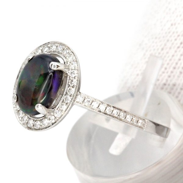 Oval Black Opal Ring with Halo of Diamonds set in 18ct White Gold