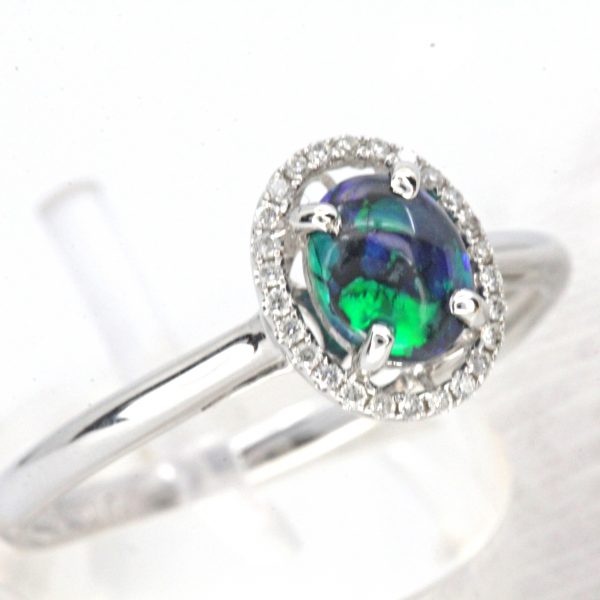 Oval Black Opal Ring with Halo of Diamonds set in 18ct White Gold